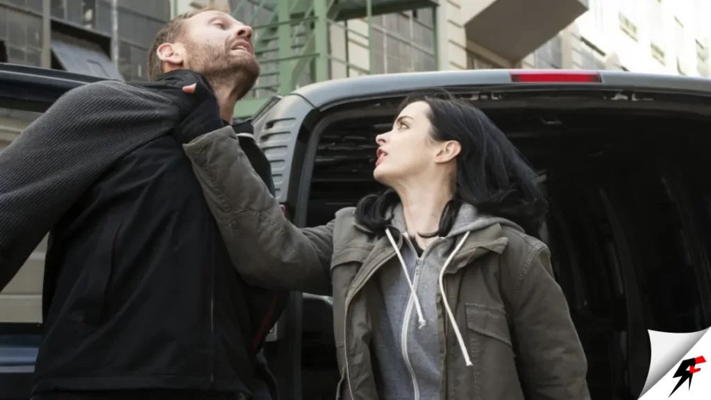 Jessica Jones holding a man with one hand